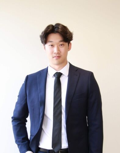 Young man in business suit promoting resources, leadership, and youth engagement.