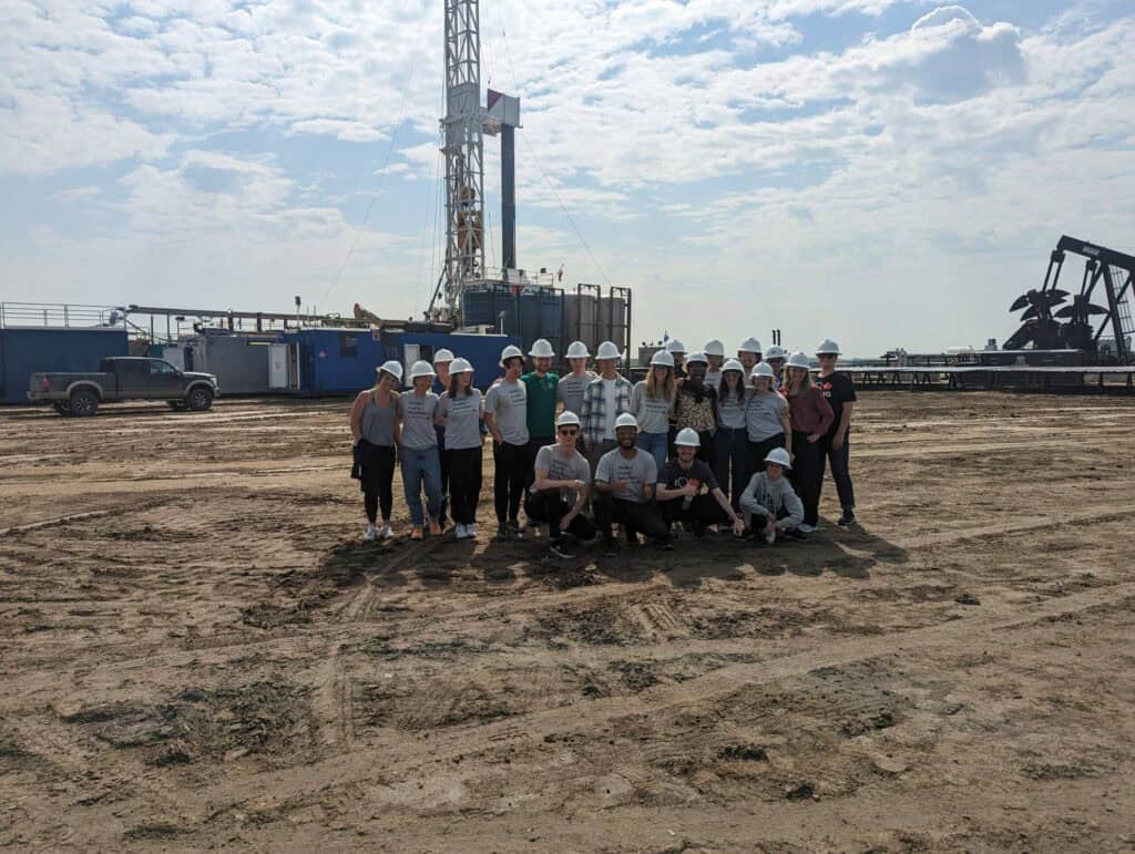 Young Canadians for Resources group at an oil drilling site promoting energy development and resource industry careers.