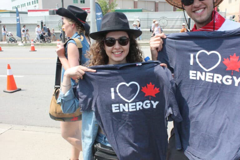 I love energy canadian supporters holding "I ♥ ENERGY" shirts at a resource industry event.